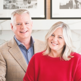 Portrait of Rochelle and Rick Declute, top-producing real estate agents recognized as the number one agents in The Beaches neighborhood of Toronto, Ontario.